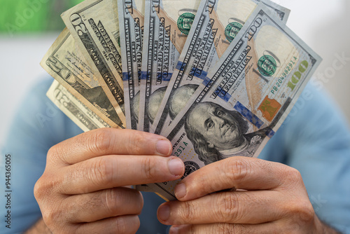 Cuadro en lienzo Male financial manager demonstrates dollar banknotes fan after successful curren