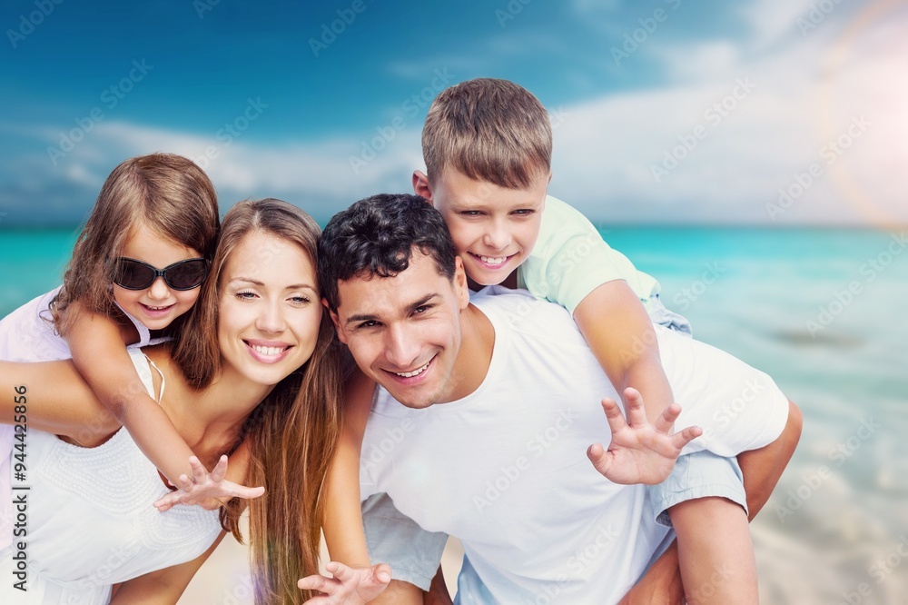 Happy young family and children on the beach on vacation Happy young family and children on the beach on vacation