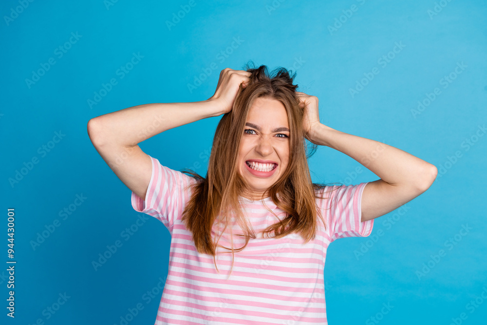 Photo of crazy mad woman wear trendy striped clothes isolated on blue color background Photo of crazy mad woman wear trendy striped clothes isolated on blue color background