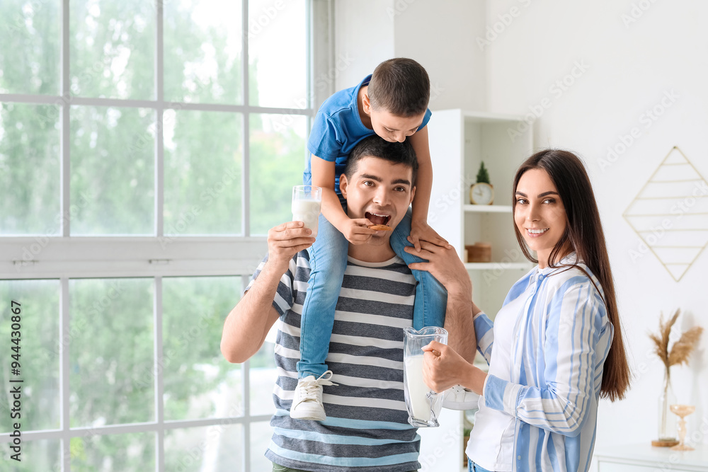 Little boy and his parents eating cookies with milk at home Little boy and his parents eating cookies with milk at home