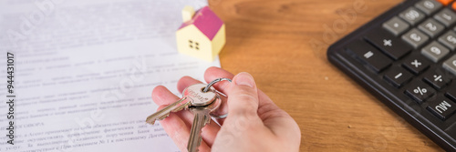 Fotografi Real estate agent handed over the key to new home, marking a successful investment in business of property, whether it be a house or an apartment