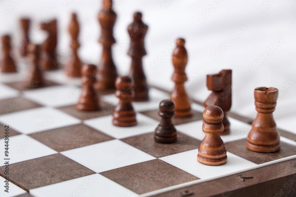 Chess pieces on game board in bedroom, closeup Chess pieces on game board in bedroom, closeup
