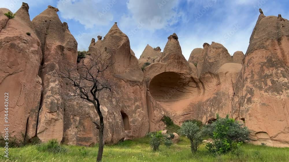 The picturesque Zelve Valley in cloudy weather in Turkey. Unusual rock formations that tell ancient stories about Cappadocia. Rocks that once had houses carved by ancient inhabitants. 4K The picturesque Zelve Valley in cloudy weather in Turkey. Unusual rock formations that tell ancient stories about Cappadocia. Rocks that once had houses carved by ancient inhabitants. 4K
