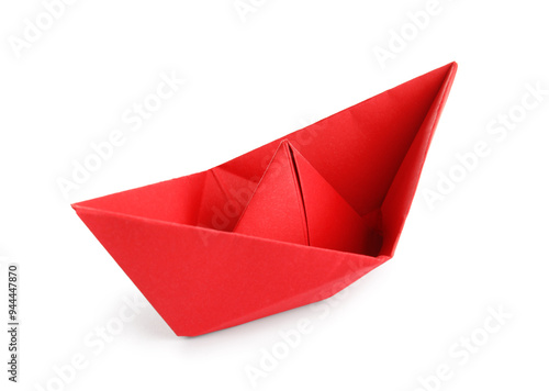 Red origami boat on white background