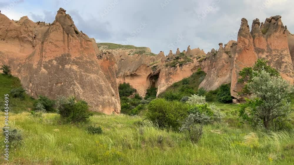 The picturesque Zelve Valley in cloudy weather in Turkey. Unusual rock formations that tell ancient stories about Cappadocia. Rocks that once had houses carved by ancient inhabitants. 4K