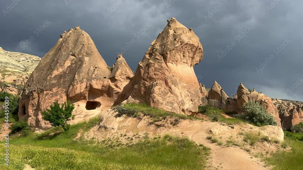 The picturesque Zelve Valley in cloudy weather in Turkey. Unusual rock formations that tell ancient stories about Cappadocia. Rocks that once had houses carved by ancient inhabitants. 4K The picturesque Zelve Valley in cloudy weather in Turkey. Unusual rock formations that tell ancient stories about Cappadocia. Rocks that once had houses carved by ancient inhabitants. 4K