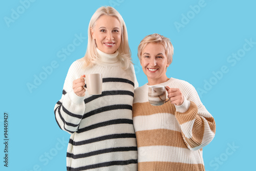Mature women with cups of t...