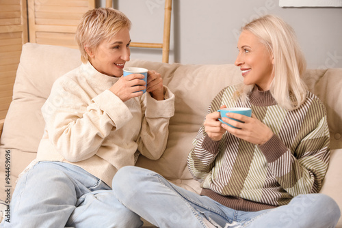 Mature women with cups of t...