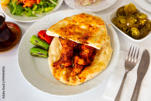 Принти на полотні Appetizing spicy chicken shish taouk (Sis tavuk) served with lavash and vegetables
