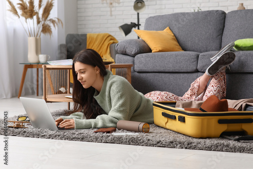 Young woman using laptop ne...