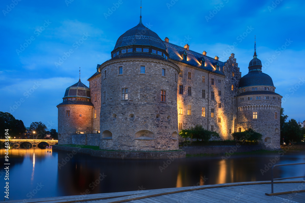 Massive Orebro Castle and Svartan river by night . Tourist atraction and history entusiast destination. Sweden. Copy space Massive Orebro Castle and Svartan river by night . Tourist atraction and history entusiast destination. Sweden. Copy space