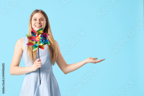 Young woman with toy windmi...
