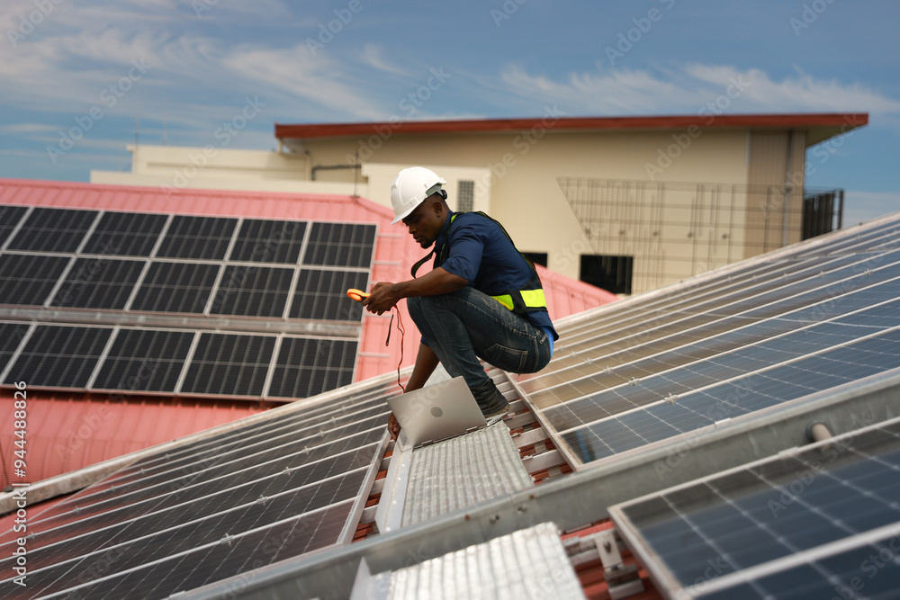 worker installing solar photovoltaic panels on a roof, Solar power plant engineers, and examining photovoltaic panels. Electrical and instrument technicians use laptop to maintenance electric solution worker installing solar photovoltaic panels on a roof, Solar power plant engineers, and examining photovoltaic panels. Electrical and instrument technicians use laptop to maintenance electric solution