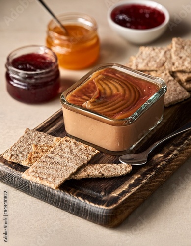 Traditional Norwegian brunost (brown cheese) served with crispbread and fruit preserves photo