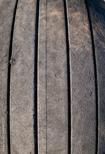 The tire has a worn out appearance with a black and grey color