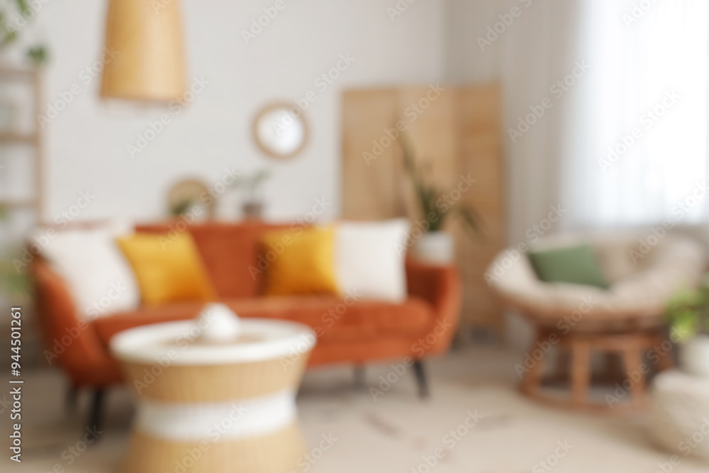 Blurred view of living room with red sofa, armchair and plants Blurred view of living room with red sofa, armchair and plants