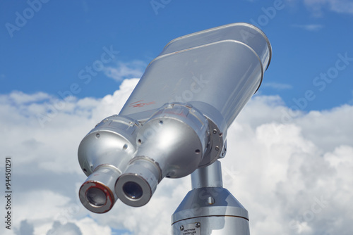 Street binoculars on a background of blue sky