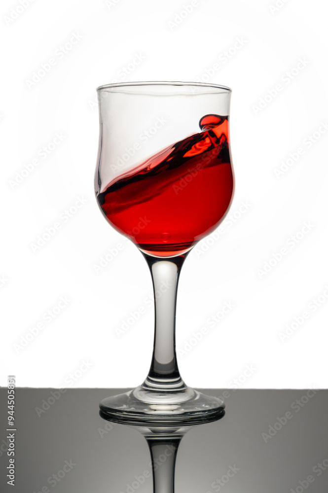 Red wine swirling into glass Red wine swirling into glass