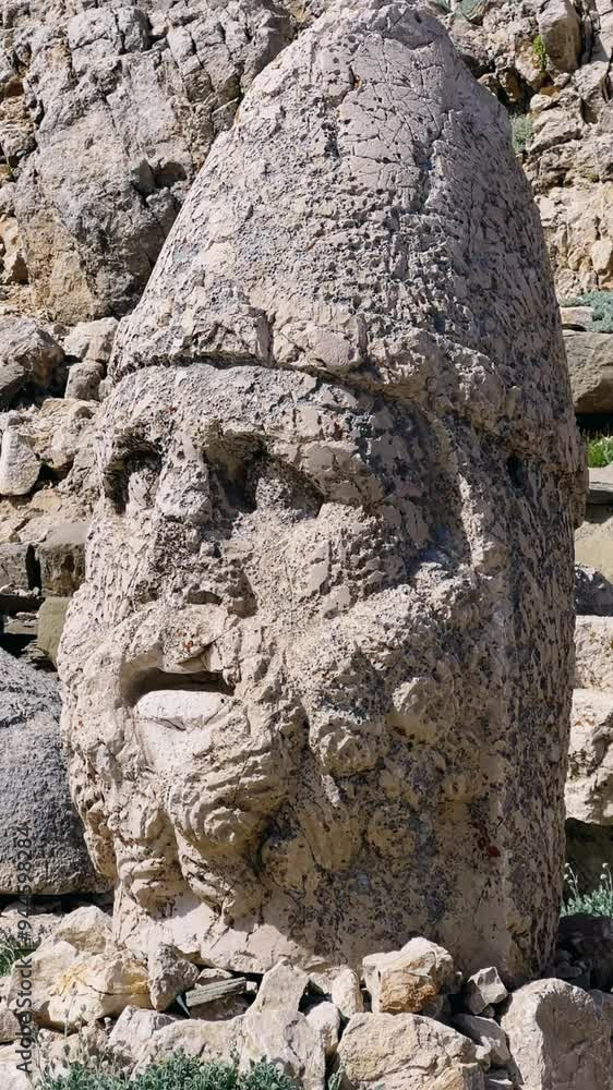 The great archaeological ruins at the top of Mount Nemrut. Destroyed antique statues. Ancient stone heads on the top of Mount Nemrut with a height of 2,150 meters. The royal tomb of the 1st century BC The great archaeological ruins at the top of Mount Nemrut. Destroyed antique statues. Ancient stone heads on the top of Mount Nemrut with a height of 2,150 meters. The royal tomb of the 1st century BC