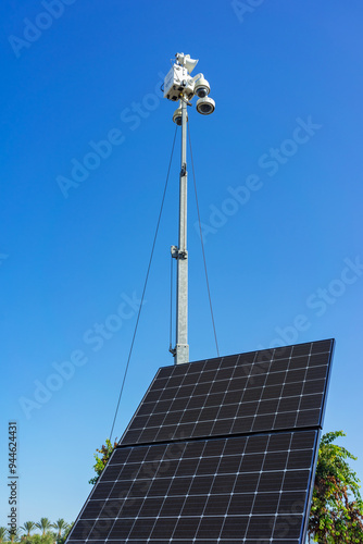 Mobile CCTV surveillance camera unit with solar panel and blue sky