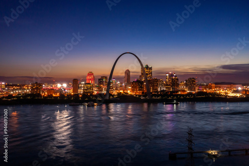 Gateway Arch National Park, the Mississippi River and city skyline at sunset. St Louis, Missouri, United States.