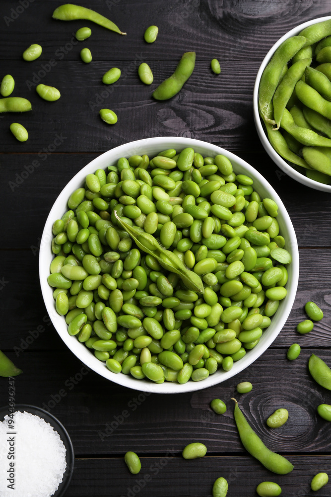 Raw green edamame soybeans and pods on wooden table, flat lay Raw green edamame soybeans and pods on wooden table, flat lay