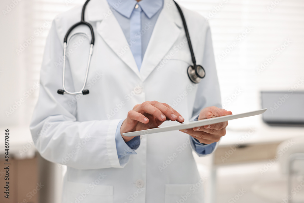 Doctor using tablet in hospital, closeup view Doctor using tablet in hospital, closeup view