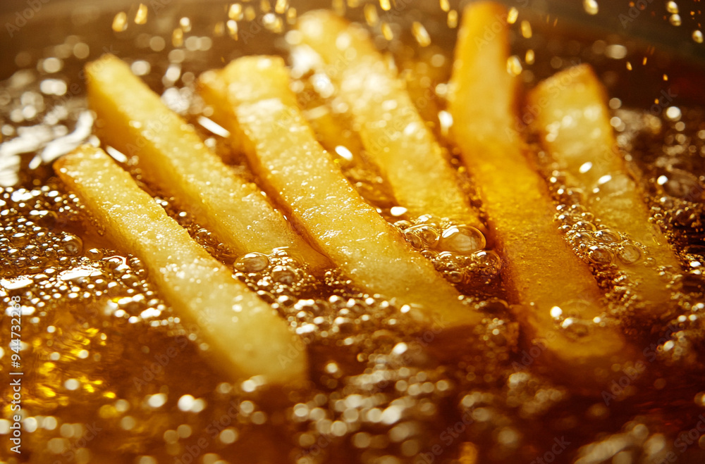 French fries being fried in oil French fries being fried in oil