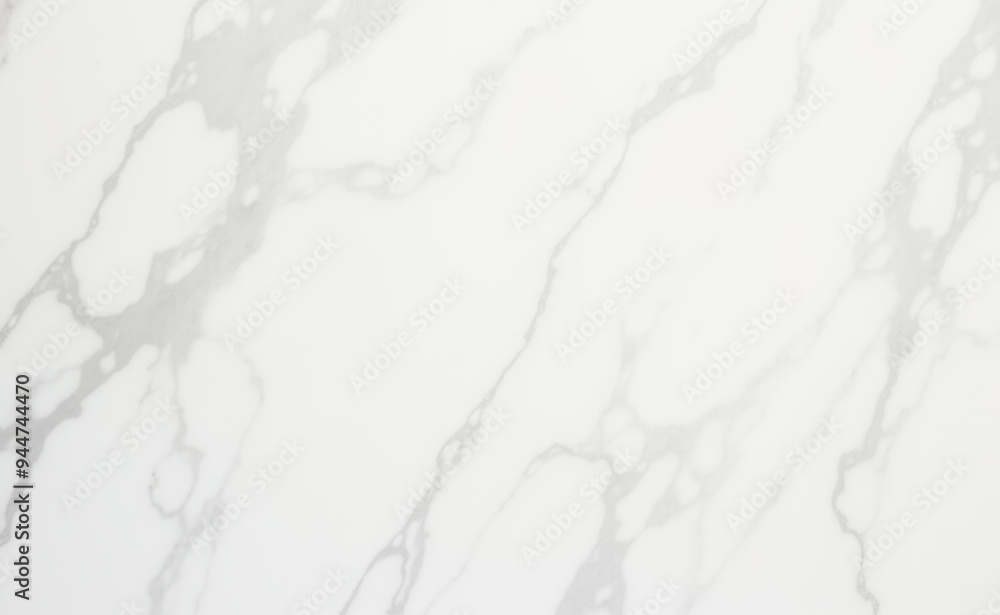 A white marble countertop with a pattern of white and gray swirls A white marble countertop with a pattern of white and gray swirls