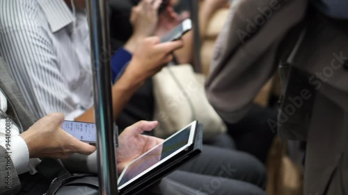 No face Asian passengers using smartphone in train public transportation