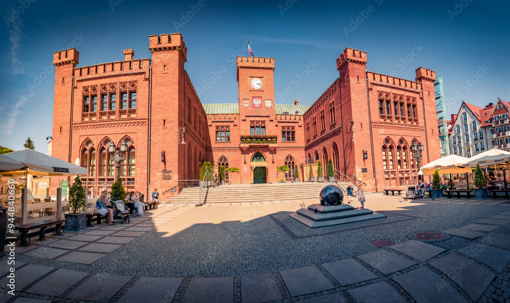 Fototapeta premium Colorful summer view of Old Town Hall in Kolobrzeg city, Poland, Europe. Wonderful afternoon cityscape of Kolobrzeg, Polish city on the Baltic Sea. Traveling concept background..