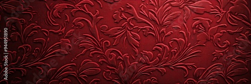 Elegant red embossed floral pattern on textured background.