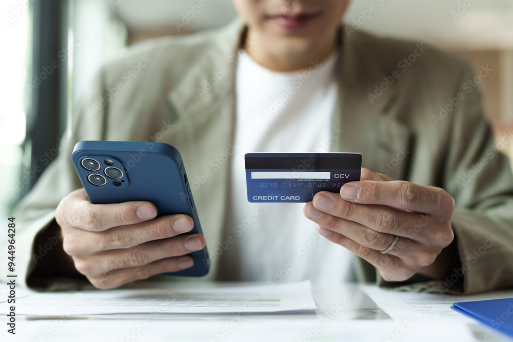 Close up hand using mobile phone and credit card for online payment, electronic wallet. Close up hand using mobile phone and credit card for online payment, electronic wallet.