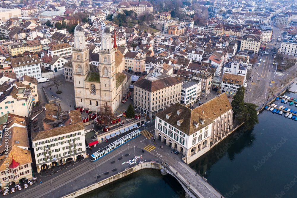 Zurich, Switzerland: Aerial drone view Zurich old town city center along the Limmat river with the Grossmunster cathedral in Switzerland largest city.