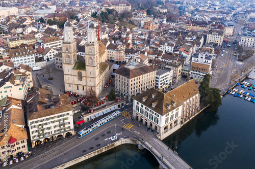 Obraz na płótnie Zurich, Switzerland: Aerial drone view Zurich old town city center along the Limmat river with the Grossmunster cathedral in Switzerland largest city. w salonie