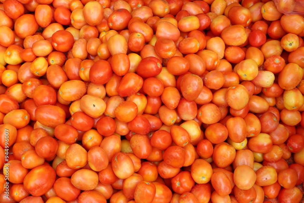 Heap of red ripe tomatoes in a vegetable whole sale market in India Heap of red ripe tomatoes in a vegetable whole sale market in India
