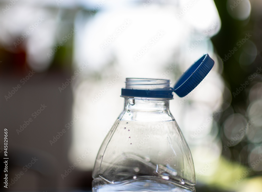 Close-up photo shows the mouth of a plastic bottle with its cap embedded in it and unable to separate from the bottle .New rules for plastic bottles in European Union. Close-up photo shows the mouth of a plastic bottle with its cap embedded in it and unable to separate from the bottle .New rules for plastic bottles in European Union.