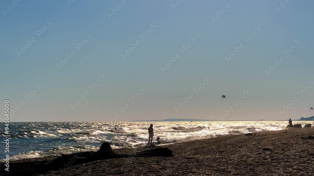 People watch the sunset on the beach in Golubitskaya. Families with children relax by the sea. People on the background of a sunset landscape, the amazing light of nature. The Sea of Azov.Golubitskaya People watch the sunset on the beach in Golubitskaya. Families with children relax by the sea. People on the background of a sunset landscape, the amazing light of nature. The Sea of Azov.Golubitskaya