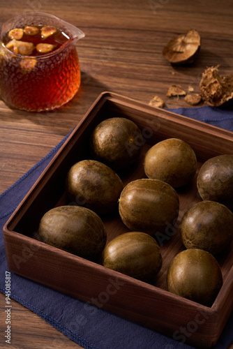 Chinese traditional medicine monk fruit, wooden background atmosphere photo