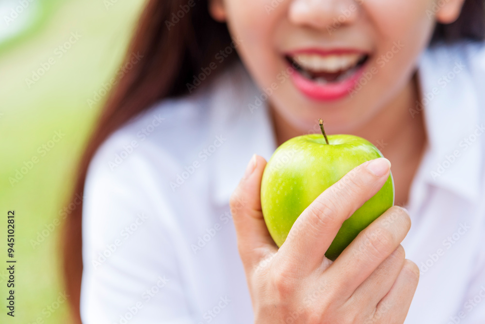young asian woman eating green Apple Healthy. Girl workout holding organic apple fruit healthy lifestyle. Wellness Asian women eat green apple smile face look at camera. Beauty health care lifestyle young asian woman eating green Apple Healthy. Girl workout holding organic apple fruit healthy lifestyle. Wellness Asian women eat green apple smile face look at camera. Beauty health care lifestyle