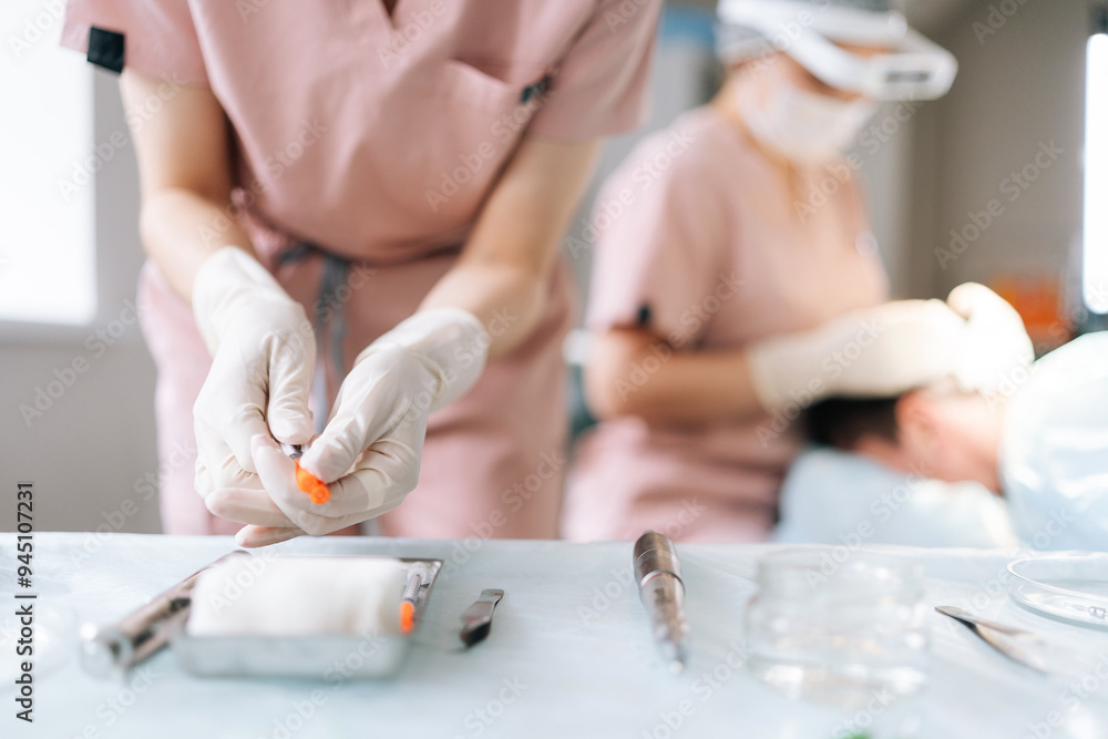 Close-up cropped shot of unrecognizable nurse assistant removing cap from needle of syringe, preparing to operation at hospital. Surgery doctor preparing syringe medicine for procedure in clinic Close-up cropped shot of unrecognizable nurse assistant removing cap from needle of syringe, preparing to operation at hospital. Surgery doctor preparing syringe medicine for procedure in clinic