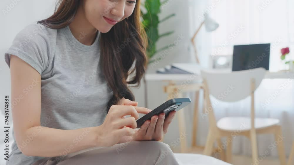 Asian attractive woman use mobile phone chat on bed at home in morning. Asian attractive woman use mobile phone chat on bed at home in morning.