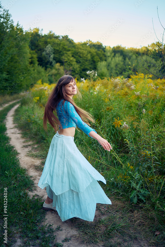 woman in whimsical aesthetic style dress in field in summer at sunset woman in whimsical aesthetic style dress in field in summer at sunset