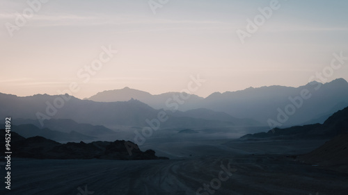 Photography night desert landscape with rocky mountains and sunset sky with clouds in Sharm