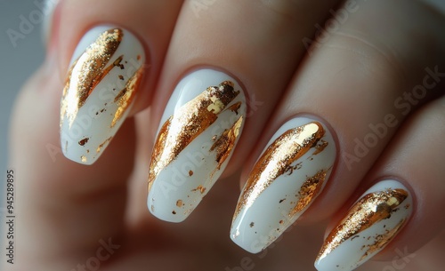 Elegant white and gold nail design featuring intricate patterns and glitterin...