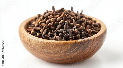 A wooden bowl of cloves isolated on a white background 