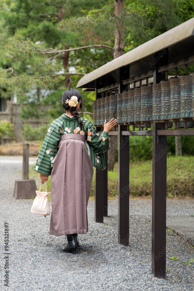 Unidentified Japanese woman in wearing traditional Hakama standing in a shrine. Unidentified Japanese woman in wearing traditional Hakama standing in a shrine.