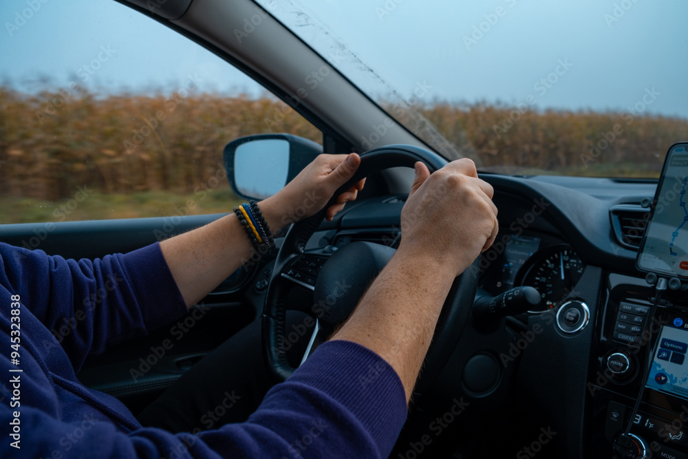 Person Driving by the road at foggy autumn highway