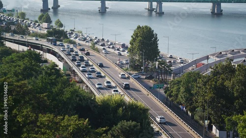 Daytime Traffic Flow on Nodeul Road and Hangang Bridge Overlooking Han River in Seoul