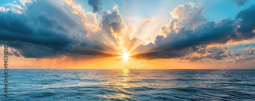 Sun rays breaking through dark storm clouds over the ocean, dramatic weather, hope after the storm